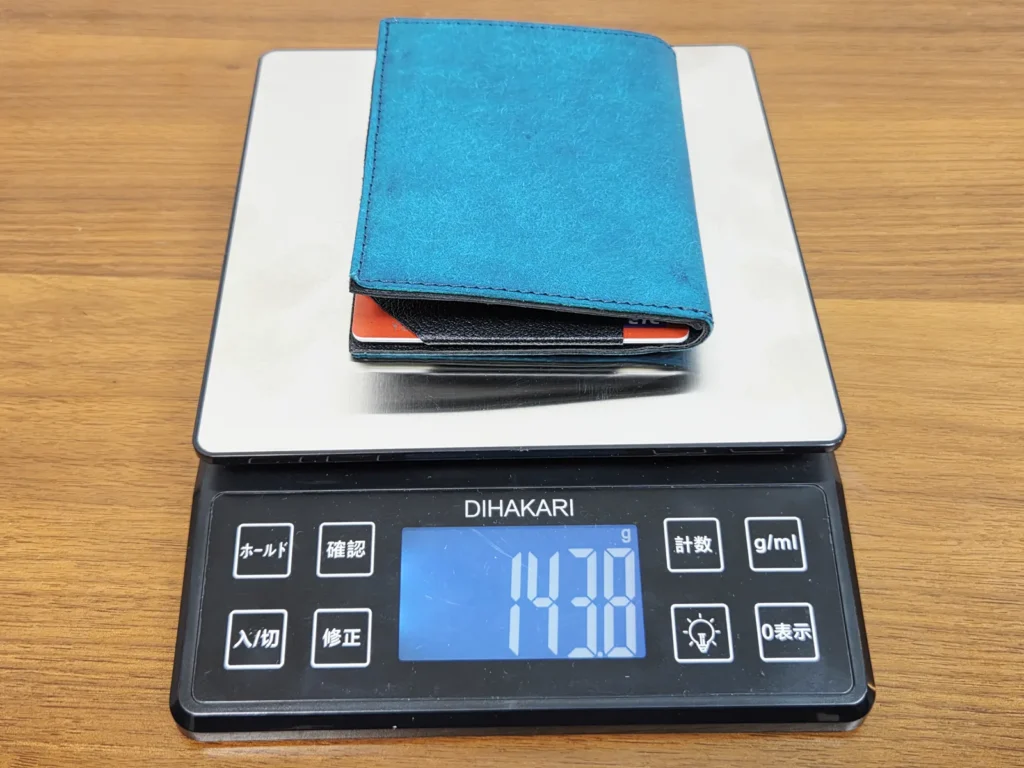 中身を入れたTenuis フラップタイプをキッチンスケールに乗せたところ、表示は143.8g